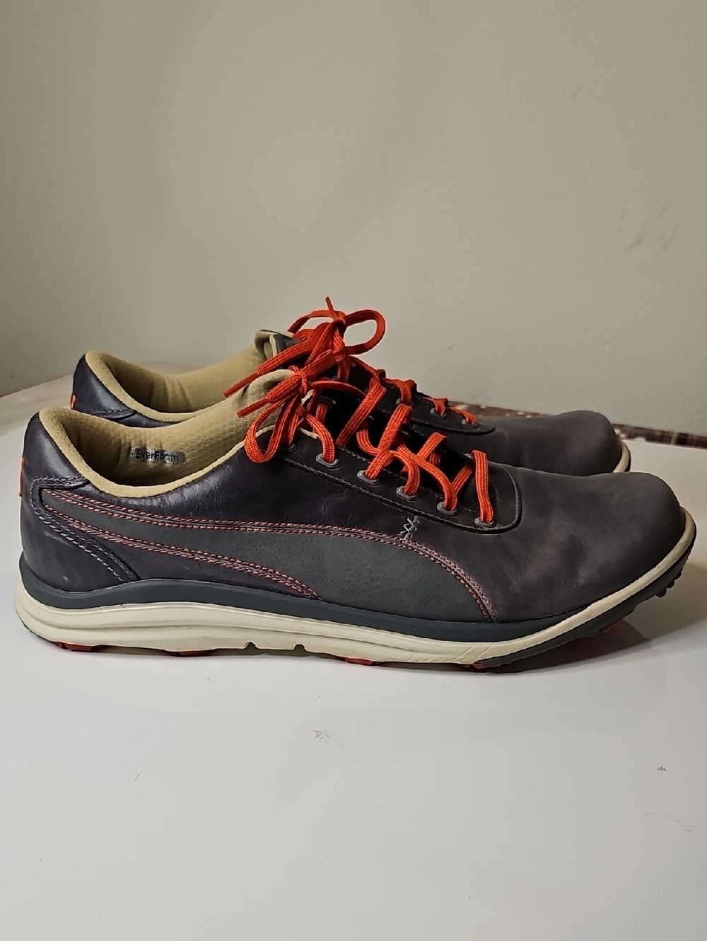 Puma BioDrive Leather men's golf shoes in a gray and spicy orange colorway.